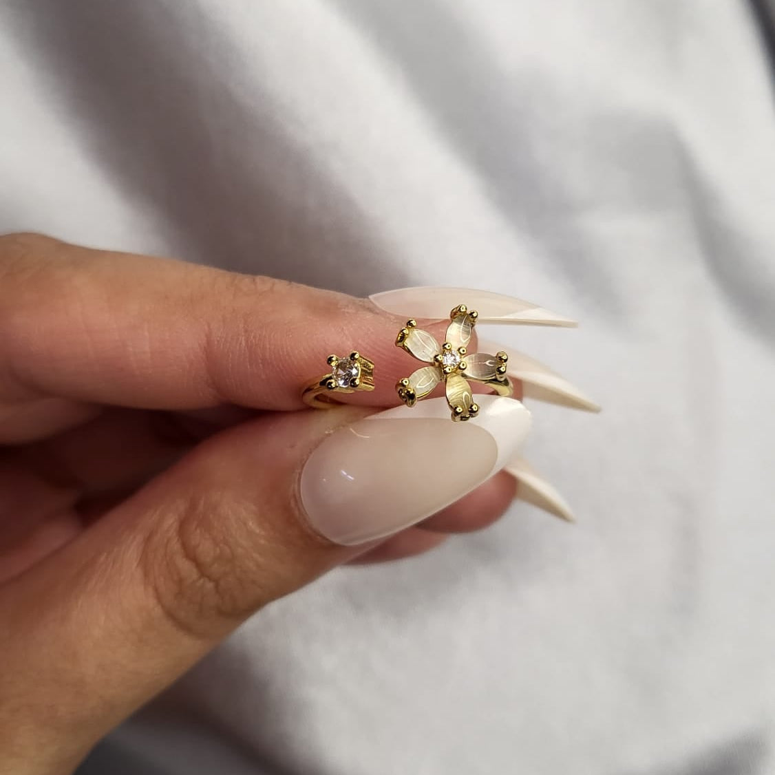 Gold rings with floral designs on a white background